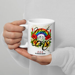 Tasse avec l’inscription “Mort aux cons” entourée de fleurs tropicales colorées, d’un arc-en-ciel et d’étoiles.